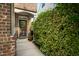 Inviting front entrance features a charming front door, beautiful brick work, and lush landscaping at 2007 October Dr, Durham, NC 27703