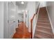 Hallway with hardwood floors leads to a staircase with carpet flooring at 2007 October Dr, Durham, NC 27703