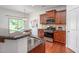Kitchen featuring stainless steel appliances, granite countertops, and wood cabinetry at 2007 October Dr, Durham, NC 27703