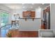 Open-concept kitchen, dining, and living areas with stainless steel appliances and hardwood floors at 2007 October Dr, Durham, NC 27703