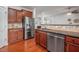 Bright kitchen with stainless steel appliances, light backsplash, sleek countertops, and beautiful hardwood floors at 2007 October Dr, Durham, NC 27703