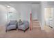 Sitting area with staircase, carpeting, and view into the laundry room at 2007 October Dr, Durham, NC 27703