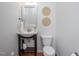 Cozy powder room with a stylish vanity, round decorative wall hangings, and hardwood floors at 2007 October Dr, Durham, NC 27703