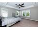 Bright bedroom with large windows, tray ceilings, and neutral walls with carpeted floors at 2008 Campana Dr, Raleigh, NC 27603