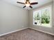 Neutral bedroom featuring a ceiling fan, window, and carpeted floor at 2008 Campana Dr, Raleigh, NC 27603