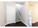 Welcoming entryway with hardwood floors, staircase, and a door leading to the upper levels at 2008 Campana Dr, Raleigh, NC 27603