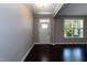 Bright foyer featuring dark hardwood floors, crown molding, a window, and a white front door at 2008 Campana Dr, Raleigh, NC 27603