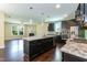 Gourmet kitchen featuring a large center island, dark cabinetry, stainless steel appliances, and hardwood flooring at 2008 Campana Dr, Raleigh, NC 27603