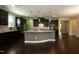 Spacious kitchen with dark cabinets, granite countertops, and a large center island, perfect for entertaining at 2008 Campana Dr, Raleigh, NC 27603