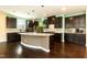 Modern kitchen with dark cabinets, granite countertops, stainless steel appliances, and a large island at 2008 Campana Dr, Raleigh, NC 27603