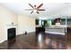 Open-concept living room leading to a kitchen, featuring hardwood floors and a cozy fireplace at 2008 Campana Dr, Raleigh, NC 27603