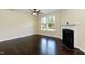 Cozy living room featuring a fireplace, dark hardwood floors, and a large window with natural light at 2008 Campana Dr, Raleigh, NC 27603