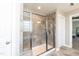 Walk-in tiled shower with a glass door, bench seating, and natural light at 2008 Campana Dr, Raleigh, NC 27603