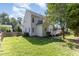 Spacious backyard with green grass and a white home exterior at 202 Chapel Valley Ln, Apex, NC 27502