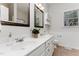 Bright bathroom with double sink vanity, tile floors, framed mirrors and wainscoting at 202 Chapel Valley Ln, Apex, NC 27502