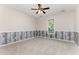 Empty bedroom with ceiling fan, neutral walls, and wood-look wainscoting at 202 Chapel Valley Ln, Apex, NC 27502