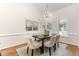 Dining room with a modern chandelier, stylish decor, and three large windows for natural light at 202 Chapel Valley Ln, Apex, NC 27502