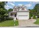 Charming two-story home features a two-car garage, inviting front porch, and well-maintained landscaping at 202 Chapel Valley Ln, Apex, NC 27502