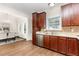Well-lit kitchen with stainless steel appliances, wood cabinets, and an adjacent dining area at 202 Chapel Valley Ln, Apex, NC 27502