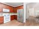 Functional kitchen with stainless steel refrigerator and wood cabinets provides ample storage and workspace at 202 Chapel Valley Ln, Apex, NC 27502