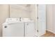 Functional laundry room with washer, dryer, and shelving at 202 Chapel Valley Ln, Apex, NC 27502