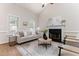Living room featuring vaulted ceilings, fireplace, and plenty of natural light from the many windows at 202 Chapel Valley Ln, Apex, NC 27502