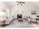 Bright living room with a fireplace, high ceiling, ceiling fan, and lots of natural light at 202 Chapel Valley Ln, Apex, NC 27502