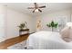 Spacious bedroom with wood floors, ceiling fan, neutral walls, and ensuite bath access at 202 Chapel Valley Ln, Apex, NC 27502