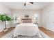 Bright main bedroom featuring a ceiling fan, wood floors, and a neutral color scheme at 202 Chapel Valley Ln, Apex, NC 27502