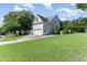 Exterior home view showing side yard and side garage door entry at 202 Chapel Valley Ln, Apex, NC 27502