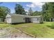 Spacious backyard featuring a well-maintained lawn and mature trees at 202 Purvis St, Garner, NC 27529