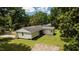 A spacious backyard features a well-maintained lawn and garden beds, with mature trees providing plenty of shade at 202 Purvis St, Garner, NC 27529