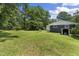 Expansive backyard with lush lawn and mature trees, offering privacy and space for outdoor activities at 202 Purvis St, Garner, NC 27529