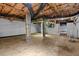 Unfinished basement with concrete columns and exposed pipes and rafters at 202 Purvis St, Garner, NC 27529