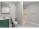 Bathroom featuring a modern vanity with a matching framed mirror and a walk-in shower at 202 Purvis St, Garner, NC 27529