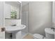 Bathroom featuring a pedestal sink and a shower with natural light streaming through the window at 202 Purvis St, Garner, NC 27529