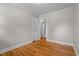 Spacious bedroom with hardwood floors and an open doorway leading to an ensuite bathroom at 202 Purvis St, Garner, NC 27529