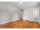 Large bedroom boasting hardwood floors, a doorway to a connecting bathroom, and neutral paint at 202 Purvis St, Garner, NC 27529