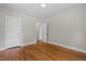 Spacious bedroom boasting hardwood floors and a doorway to an ensuite bathroom at 202 Purvis St, Garner, NC 27529