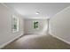 A well-lit bedroom offers plush carpet and two bright windows at 202 Purvis St, Garner, NC 27529