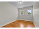 Bright bedroom featuring hardwood floors, two windows, and neutral-colored walls at 202 Purvis St, Garner, NC 27529
