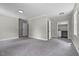 Bedroom featuring neutral carpet, multiple windows, and base trim at 202 Purvis St, Garner, NC 27529