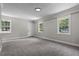 Bedroom featuring neutral carpet, great light, three windows and base trim at 202 Purvis St, Garner, NC 27529