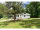 Charming home featuring a well-maintained lawn, mature tree, and a welcoming entryway with a small porch at 202 Purvis St, Garner, NC 27529