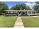 Charming single-story home with manicured lawn, newly painted exterior and inviting entryway at 202 Purvis St, Garner, NC 27529