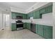Charming kitchen with stainless steel appliances, white countertops and trendy green cabinetry at 202 Purvis St, Garner, NC 27529