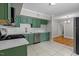 Open kitchen featuring stainless steel appliances, white countertops, and green cabinets at 202 Purvis St, Garner, NC 27529