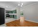 Bright kitchen features stainless steel appliances, green cabinets, and tile flooring at 202 Purvis St, Garner, NC 27529