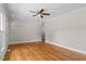 A bright living room is illuminated by large windows and a ceiling fan at 202 Purvis St, Garner, NC 27529