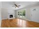 The inviting living room features natural light and a decorative brick fireplace at 202 Purvis St, Garner, NC 27529